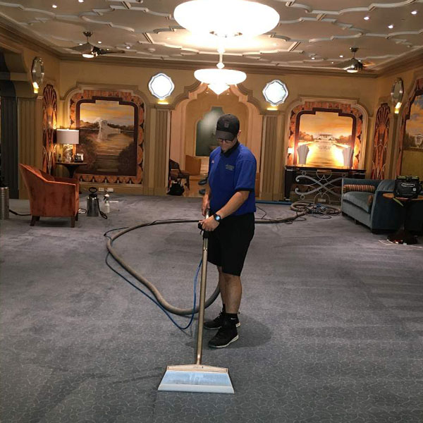 man cleaning carpet